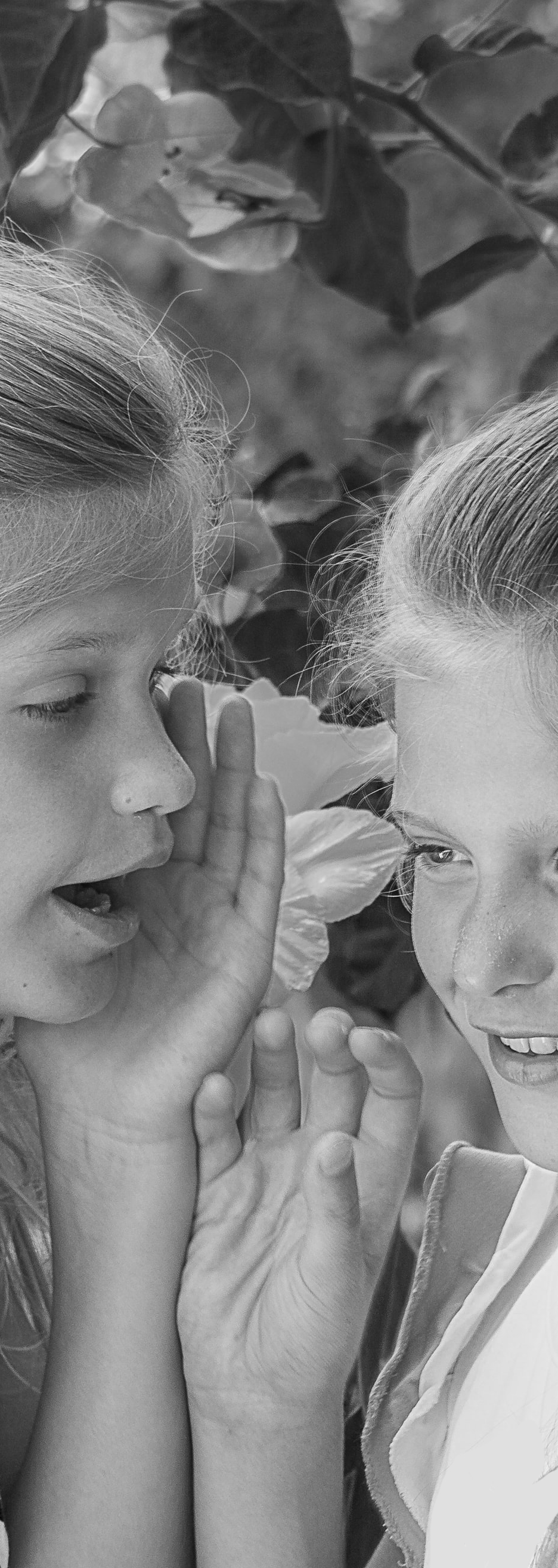 Two girls whispering to each other