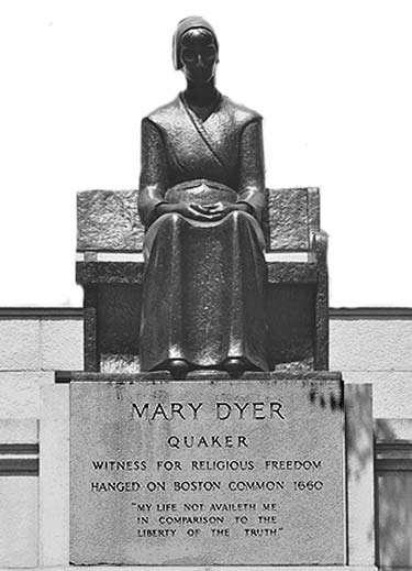 The seated Mary Dyer monument above an inscribed stone pedestal