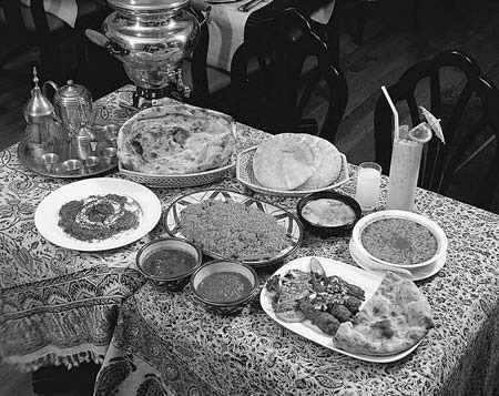 A table filled with many prepared dishes and drinks