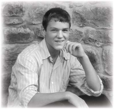 Jeremiah Stump seated in front of a stone wall.