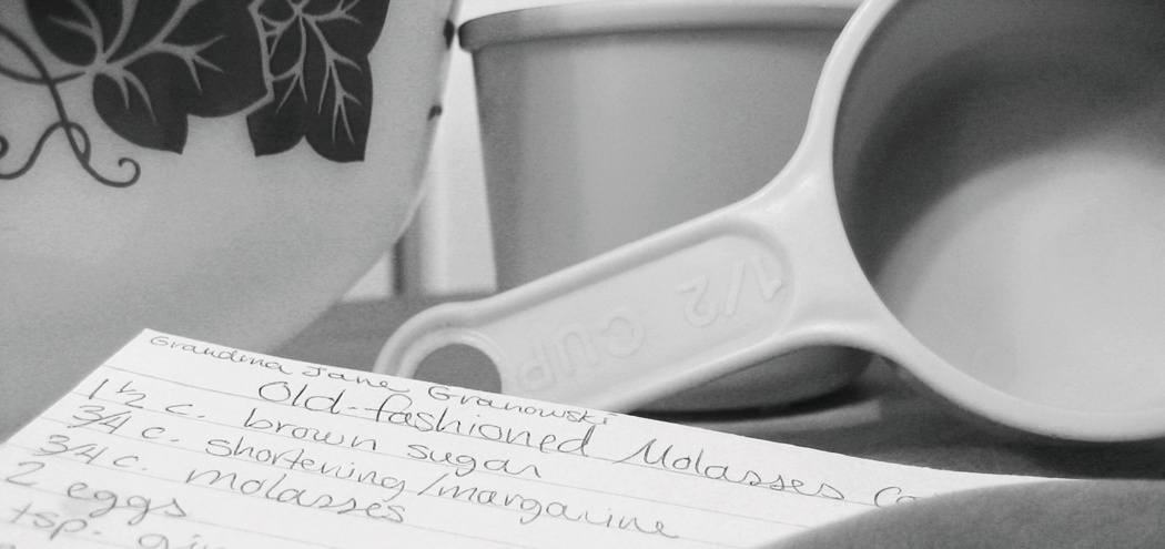 Measuring cup beside a handwritten recipe