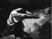 A figure bows with head in hands