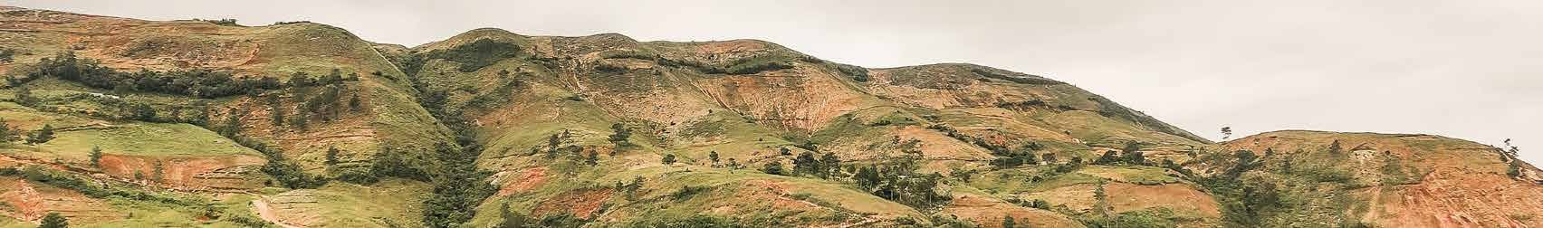 Green and brown hills under a pale sky in Haiti