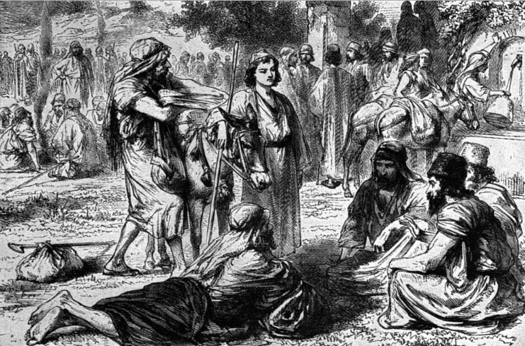 A young man standing among men and animals outdoors