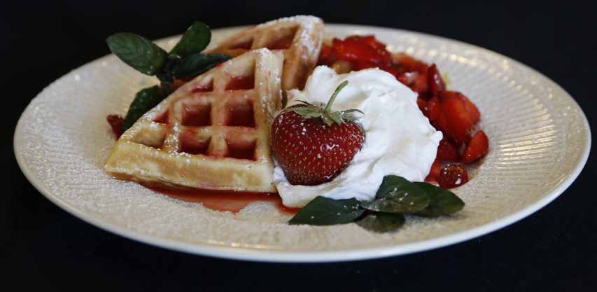 Waffles with strawberries and whipped cream