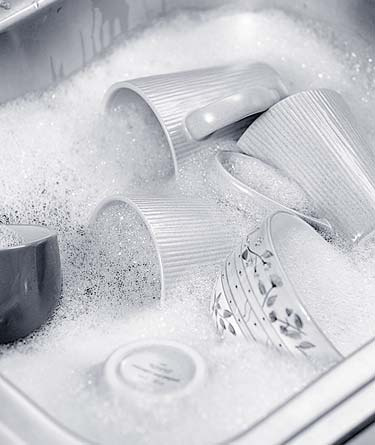 Dishes and cups in soapy water