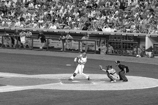 Baseball player batting in a stadium