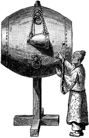 A person operating a large suspended-bell apparatus