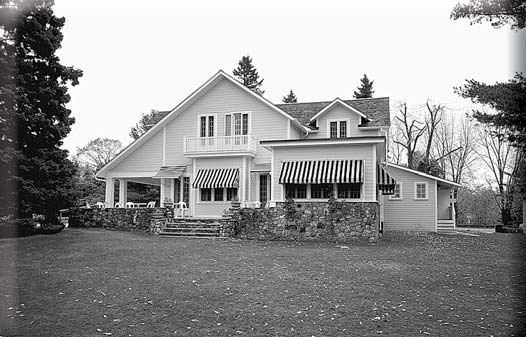 A large two-story house with striped awnings