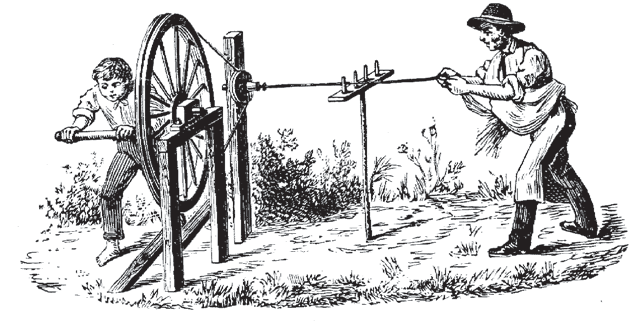 A child and a man working together at a hand turned wheel