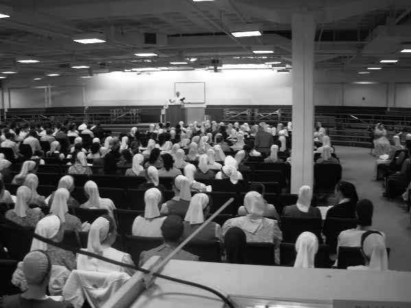Youth Bible School audience facing a speaker at the front of the hall