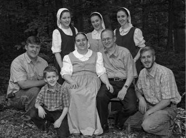 Group portrait of adults and a child outdoors