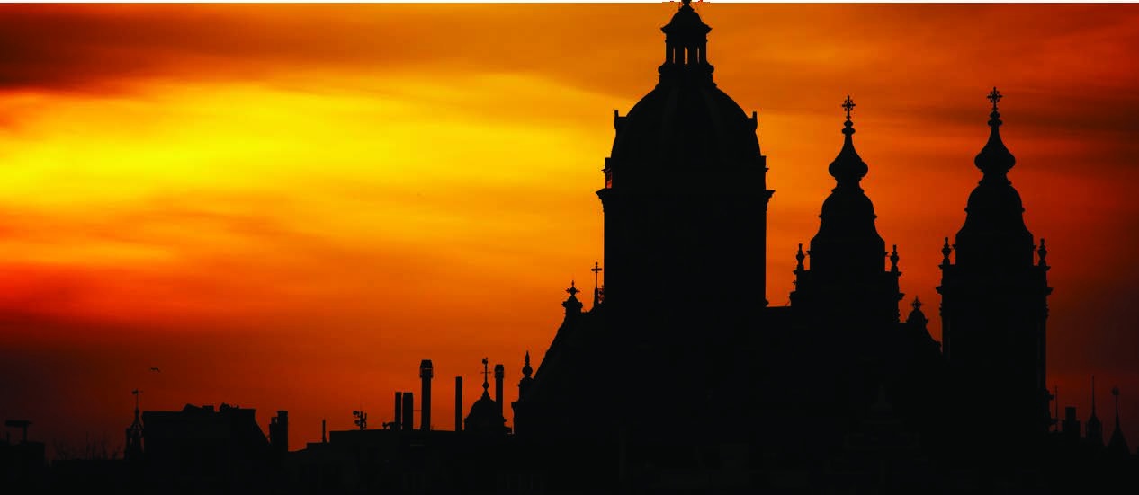Silhouette of a church against a sunset sky