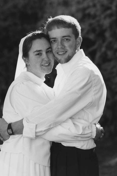 A man and woman embracing outdoors
