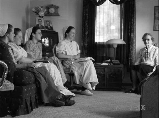 Young women sitting with an older woman during a visit.