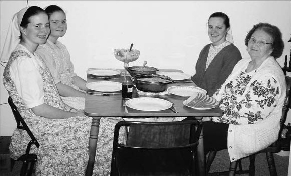 Four women seated around a dining table.