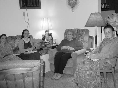 Four women seated together in a living room.