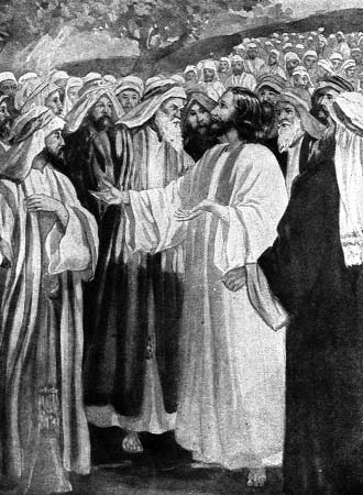 A robed man speaking amid a crowd