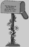 A mailbox on a flower-covered post