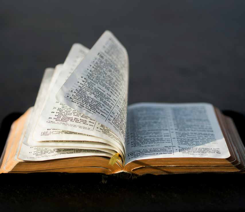 An open Bible with pages turning