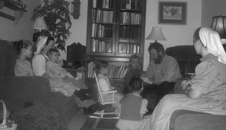Adults and children gathered in a sitting room