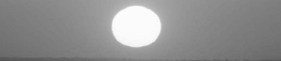 The sun above a distant horizon
