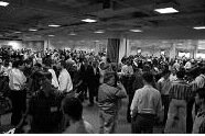 A crowd of participants stands together at an indoor gathering.