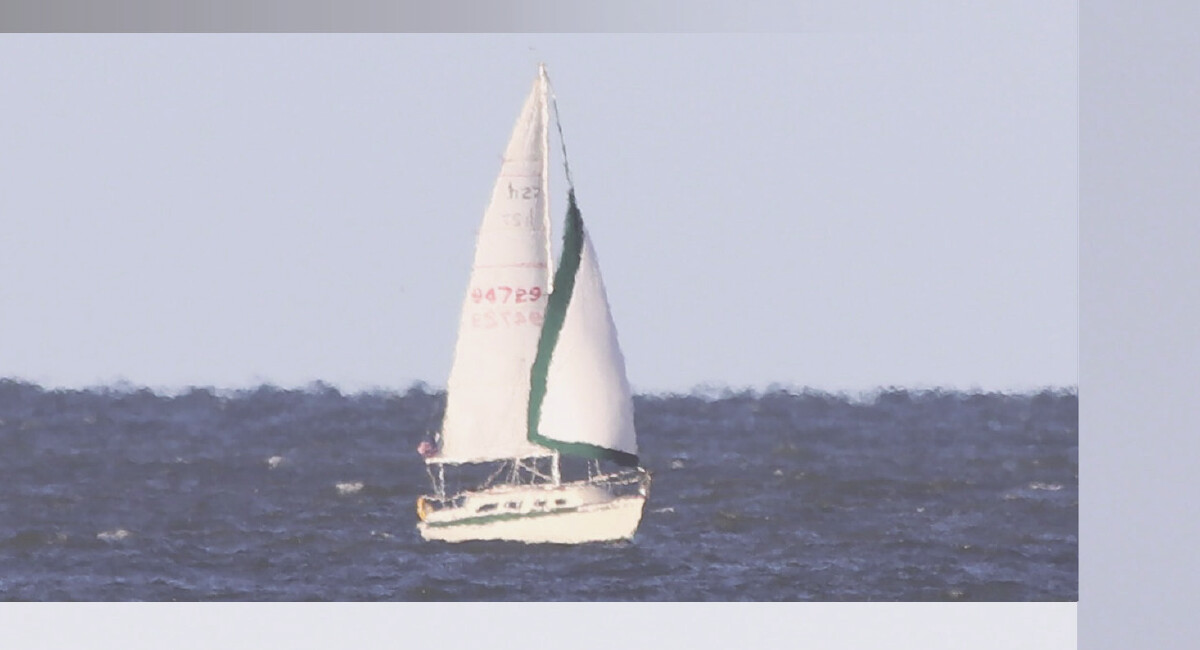 A white sailboat on dark blue water