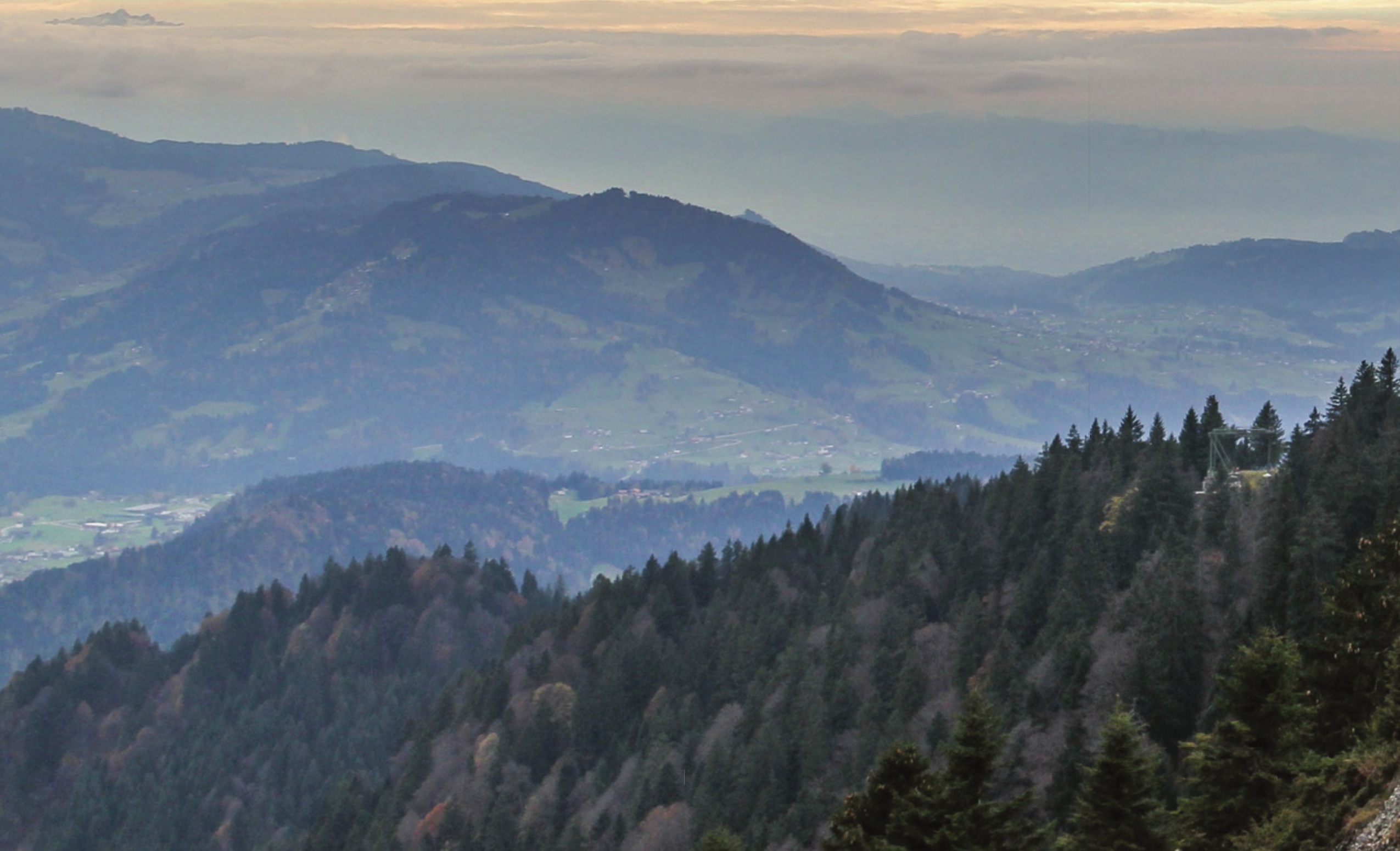 Mountain ridges and a valley beneath a cloudy sky