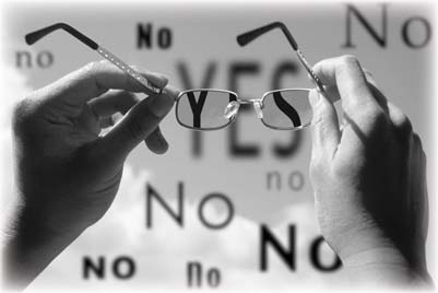 Hands hold broken eyeglasses against repeated YES and NO words.