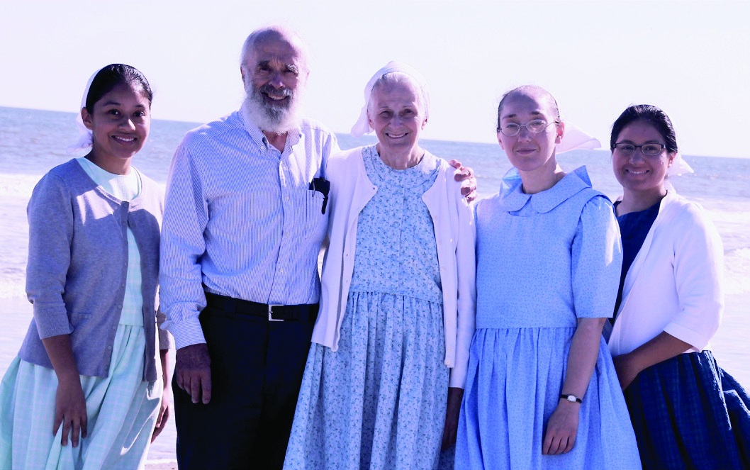 Joe and Liz Tindall standing outdoors with three of their daughters