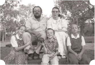 Sam and Susanna Glanzer with their three children outdoors.