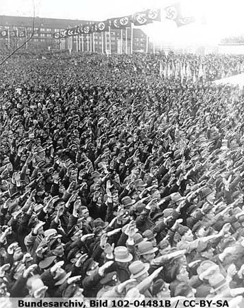 A large crowd giving the Nazi salute