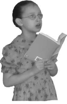 A young child sings while holding an open book.