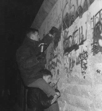 Rick and a companion hammering on the Berlin Wall