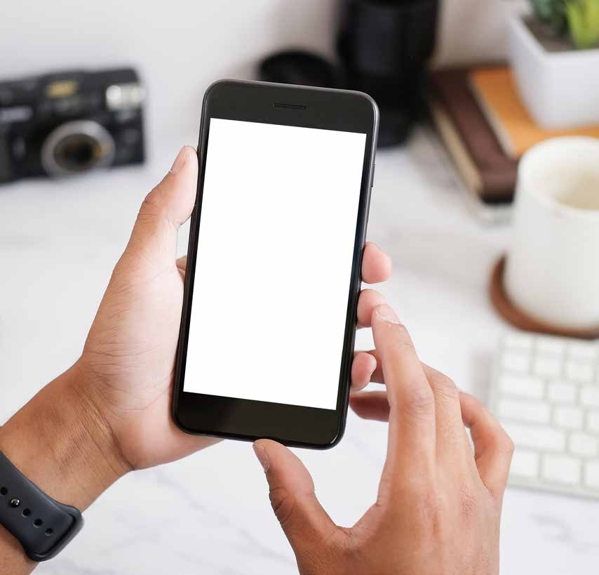 Hands holding a smartphone above a desk
