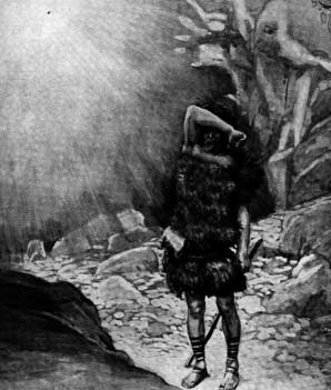 A man shielding his face from rays of light in a rocky landscape
