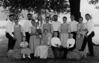 The Kenaston family gathered outdoors beneath a tree.