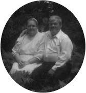 A man and woman seated together outdoors