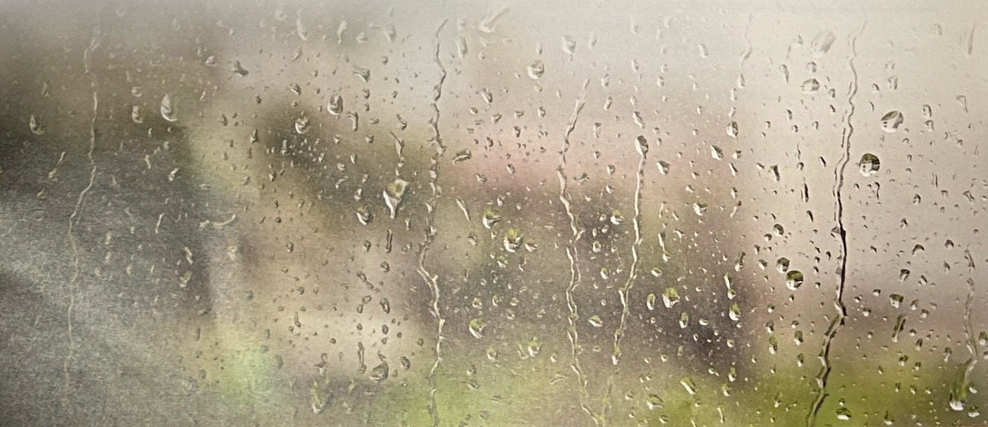 Raindrops running down a window.