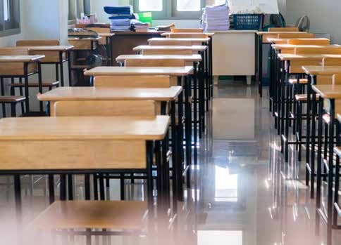 An empty classroom with rows of desks