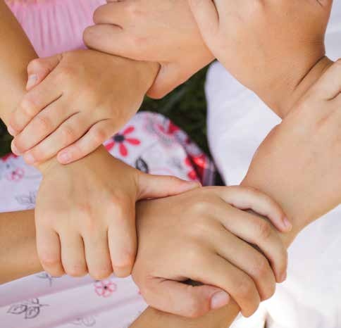 Children stacking their hands together