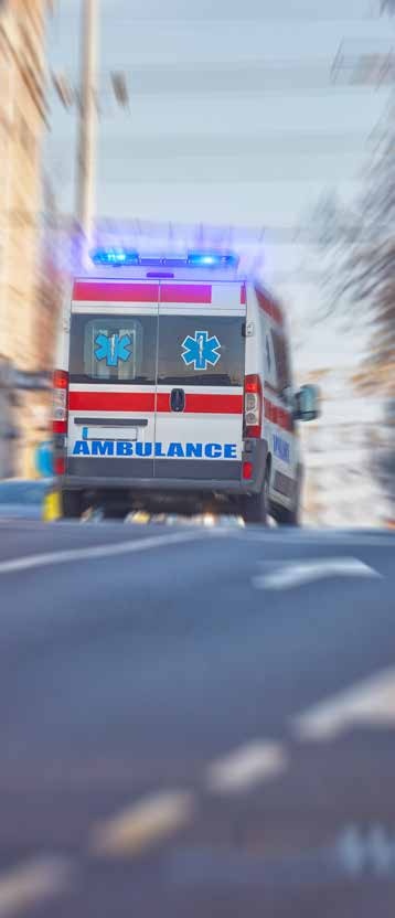 An ambulance driving with its emergency lights on