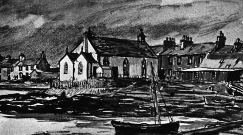 A church and waterfront buildings beside boats.