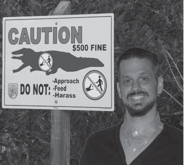 Man beside a caution sign