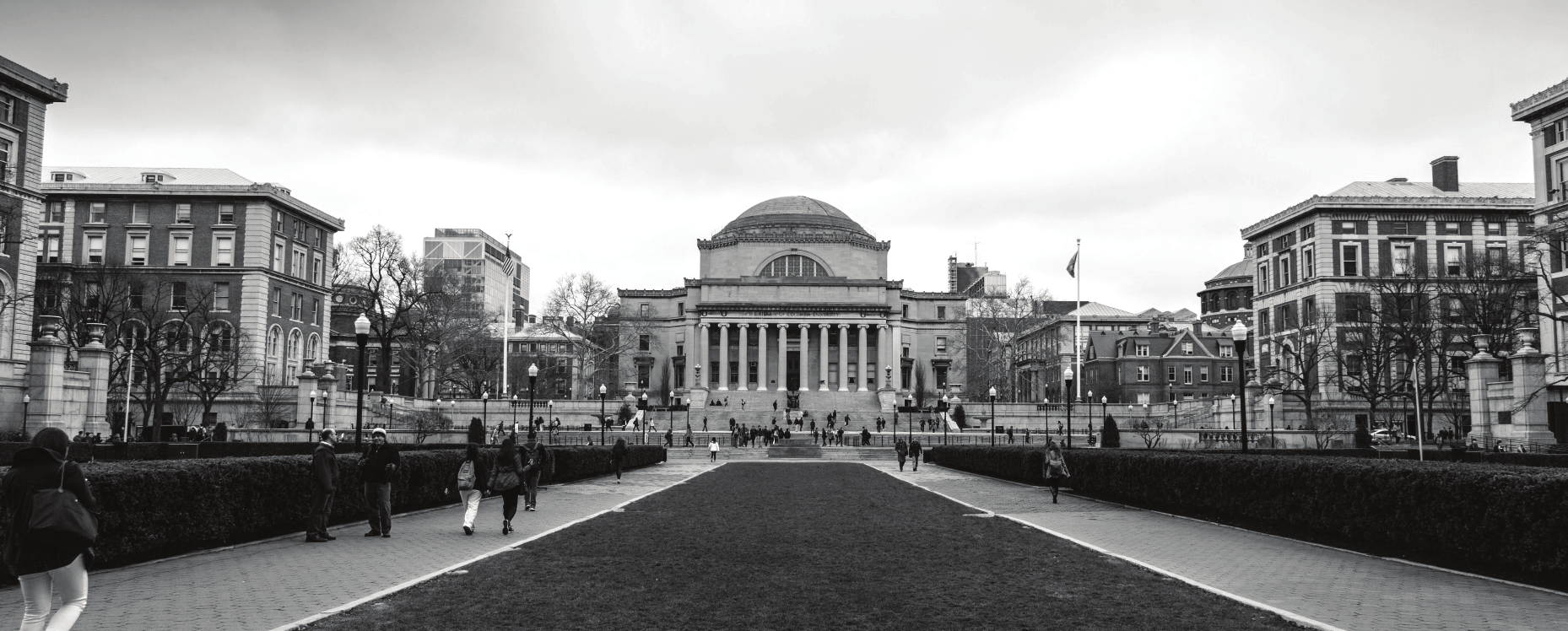 A black-and-white view across a university campus toward a domed neoclassical building