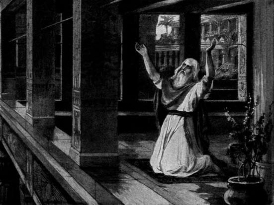 A man kneels with raised hands in prayer
