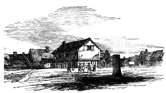 People and buildings beside a broad roadway