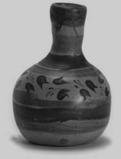 A pottery vase with a narrow neck and floral decoration.
