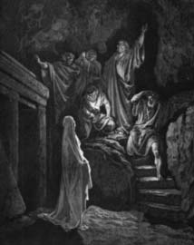 A man standing before a group gathered on stone steps.